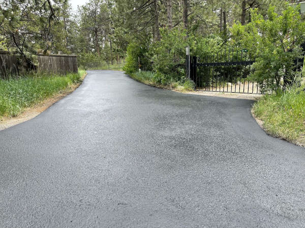 Driveway in Denver, CO with new sealcoating. Still wet to the touch