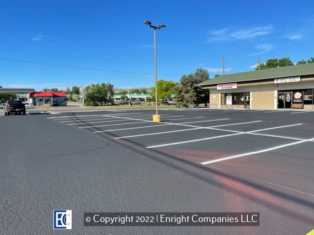 Strip Mall parking lot which has new sealcoating and parking lot striping. 