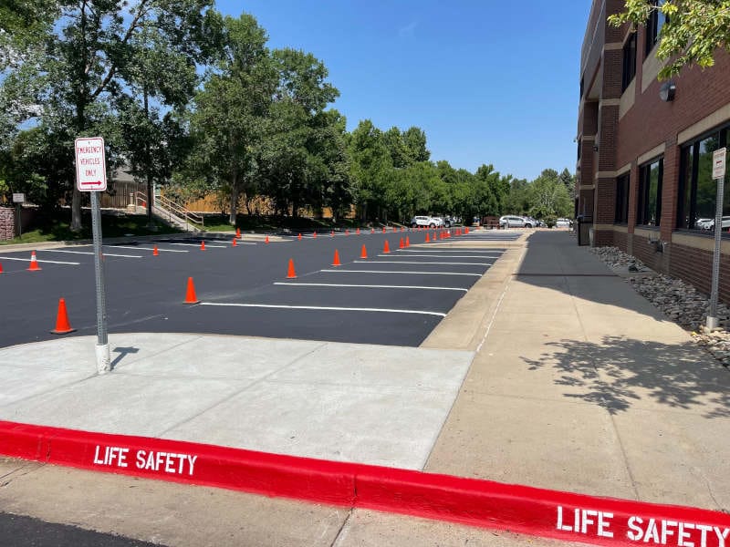 sealcoating being applied to parking lot