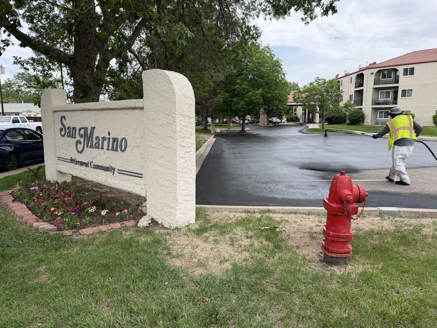 Crew spraying sealer on parking lot in Westminster, CO